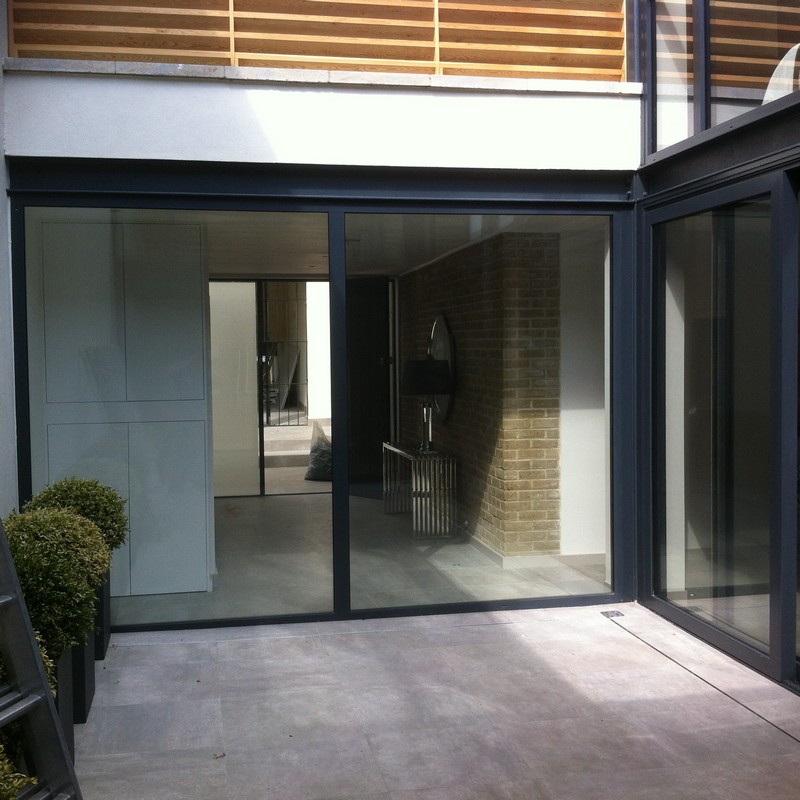 Floor-to-ceiling sliding doors opening to courtyard in Ruislip