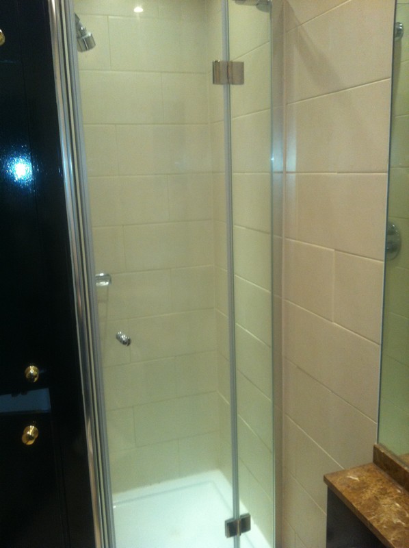 Frameless glass shower enclosure with chrome fittings in Ruislip