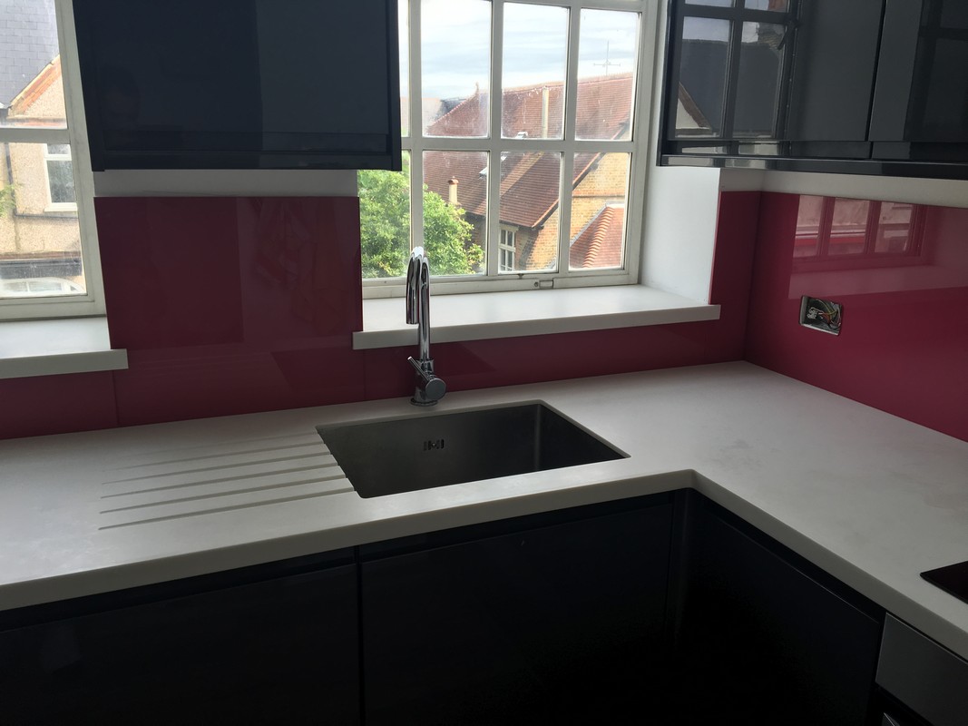 Deep plum coloured glass splashback in modern Ruislip kitchen